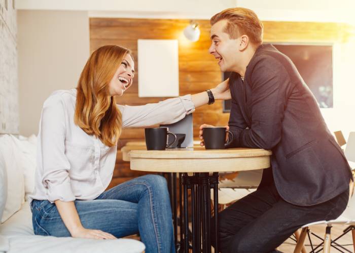 A girl and a guy drinking coffee