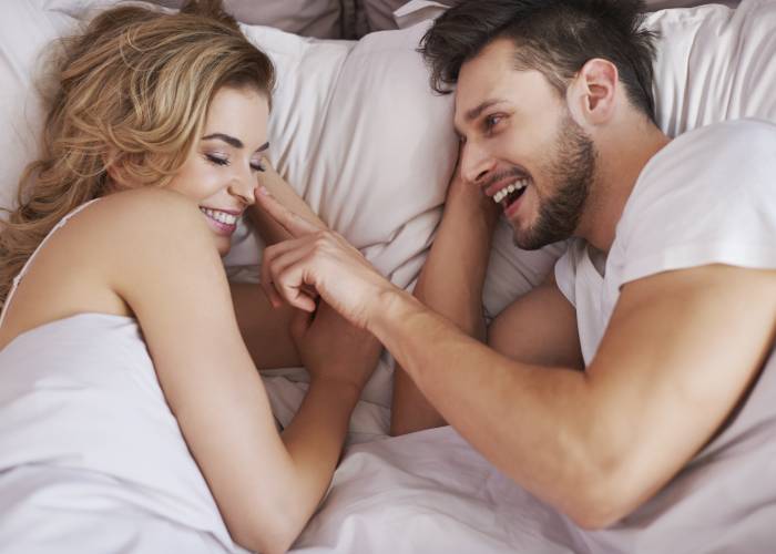 Guy and girl lying in bed